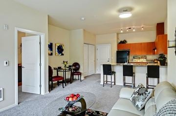 Redmond apartment for rent - A living room with a white couch and a bar area.