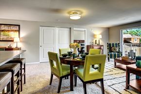 Bellevue apartment for rent - A dining room with a table set for two and green chairs.