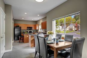 Bellevue apartment for rent - A kitchen with a table and chairs in front of a window.