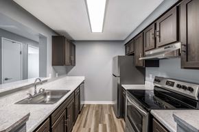 Seattle apartment for rent - A kitchen with a stove top oven and a sink.
