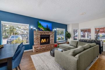 Seattle apartment for rent - A living room with a fireplace and a painting on the wall.