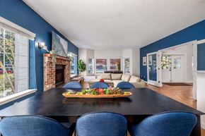 Seattle apartment for rent - A dining room with a black table and blue chairs.