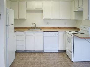 Seatac apartment for rent - A kitchen with white appliances and cabinets.