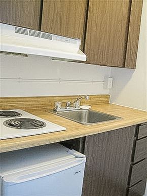Seatac apartment for rent - A kitchen with a stove top oven and a sink.