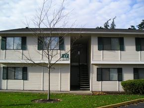 Seattle apartment for rent - A tree in front of a building with the number 17 on it.