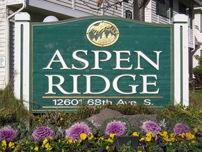 Seattle apartment for rent - A sign that says Aspen Ridge in front of some flowers.