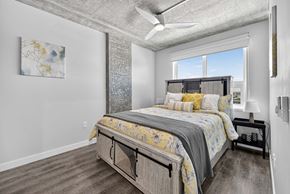 Tukwila apartment for rent - A bedroom with a large bed and a ceiling fan.