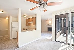 Kent apartment for rent - A room with a ceiling fan and a doorway leading to a balcony.