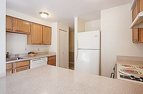 Kent apartment for rent - A kitchen with white appliances and wooden cabinets.