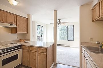 Kent apartment for rent - A kitchen with wooden cabinets and a stove top oven.