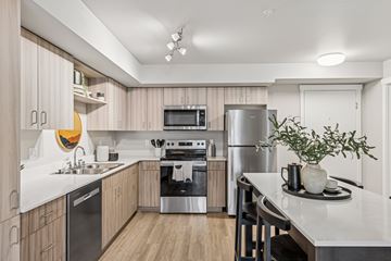 Kirkland apartment for rent - A modern kitchen with wooden cabinets and stainless steel appliances.
