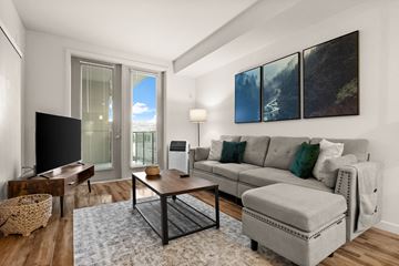Tacoma apartment for rent - A living room with a grey couch and a coffee table.