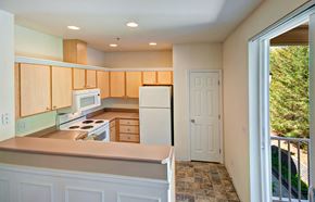 Bothell apartment for rent - A kitchen with wooden cabinets and a tiled floor.