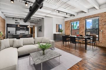 Chicago apartment for rent - a living room with a white couch and a table with chairs