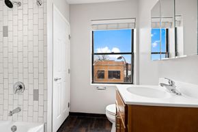 Chicago apartment for rent - a bathroom with a sink toilet and a window