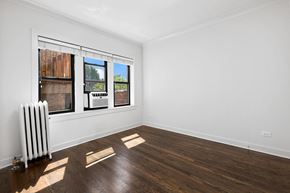 Chicago apartment for rent - a living room with a radiator and a window