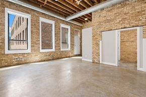 Chicago apartment for rent - the interior of a building with brick walls and a concrete floor