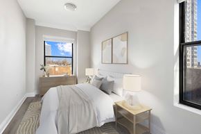 Chicago apartment for rent - A bedroom with a bed, nightstand, and window.