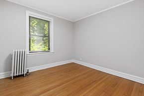 Chicago apartment for rent - an empty room with a radiator and a window