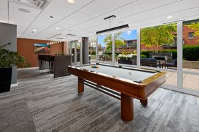 Chicago apartment for rent - a pool table in the resident lounge with a bar in the background