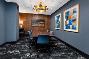 Chicago apartment for rent - a conference room with a long wooden table and blue chairs