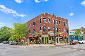 Chicago apartment for rent - a brick building with a coffee shop on the corner of a street