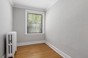 Chicago apartment for rent - a room with white walls and a window and a wooden floor