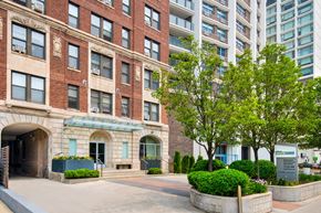 Chicago apartment for rent - an apartment building with a courtyard and trees in front of it