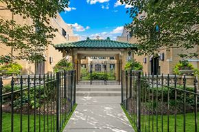 Chicago apartment for rent - a gated entrance to a building with a gazebo in the front