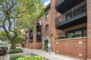Chicago apartment for rent - the apartment building has a red brick facade and a balcony