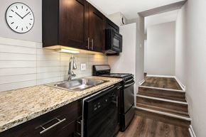 Chicago apartment for rent - a kitchen with a sink and a clock on the wall
