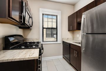 Chicago apartment for rent - a kitchen with stainless steel appliances and a window