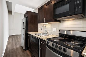 Chicago apartment for rent - a kitchen with stainless steel appliances and wooden cabinets