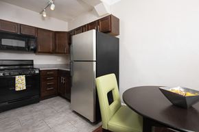 Chicago apartment for rent - a kitchen with a stainless steel refrigerator and a table