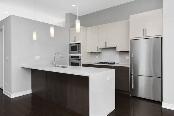 Chicago apartment for rent - a kitchen with an island and stainless steel refrigerator