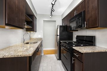 Chicago apartment for rent - a kitchen with black appliances and granite counter tops and