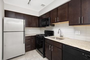 Chicago apartment for rent - a kitchen with stainless steel appliances and marble counter tops