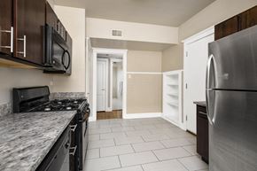 Chicago apartment for rent - a kitchen with stainless steel appliances and marble counter tops