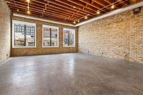 Chicago apartment for rent - an empty room with brick walls and a concrete floor