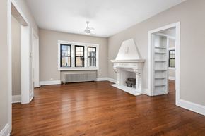 Chicago apartment for rent - a living room with a fireplace and a book shelf
