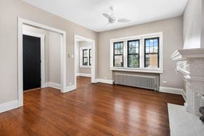 Chicago apartment for rent - an empty living room with hardwood floors and a fireplace