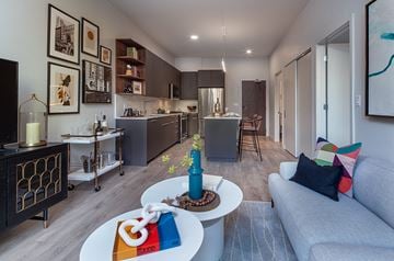 Chicago apartment for rent - A modern living room with a grey couch and a coffee table.