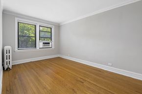 Chicago apartment for rent - an empty room with wooden floors and a window