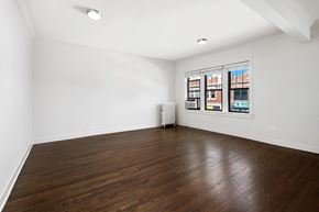 Chicago apartment for rent - an empty living room with wood floors and white walls