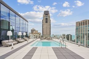 Chicago apartment for rent - A rooftop pool area with a tall building in the background.