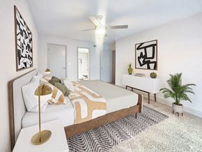 Winter Haven apartment for rent - A bedroom with a bed, a lamp, and a ceiling fan.