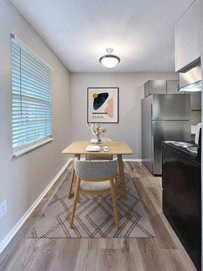 Fort Walton Beach apartment for rent - A dining room with a wooden table and a chair.