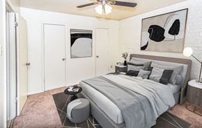 Baton Rouge apartment for rent - A bedroom with a bed, a ceiling fan, and a painting on the wall.