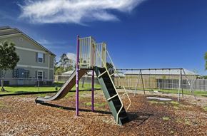 Baton Rouge apartment for rent - A playground with a green slide and a purple railing.