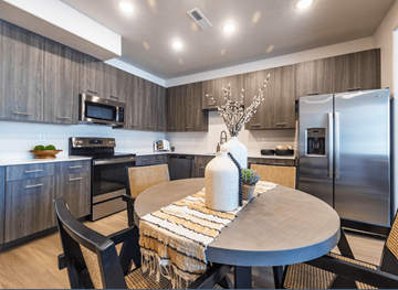 Draper townhouse for rent - A modern kitchen with a dining table set for two.